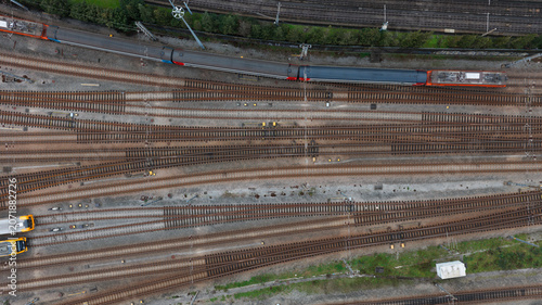 Fotografie Top-Down View of Railway Tracks Converging at Major Train Station