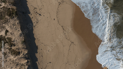 Top down aerial view of a beach on the coastline of Portugal. 