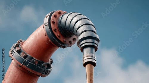Industrial Pipework Against Sky: A close-up of industrial pipework, featuring a red curved pipe connected to a metal conduit, set against a clear blue sky.