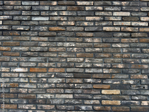 Photography Weathered bricks form a textured wall, showcasing visible mortar lines and varying shades of red and brown