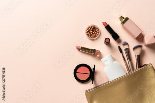 Cosmetic bag with brushes, lipstick, parfum, shadow.