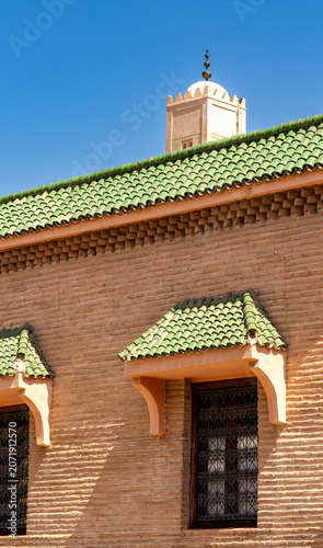 Traditional Moroccan Architecture with Green Tiled Roof and Minaret in Marrakech Medina