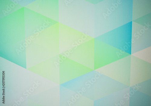Wallpaper background, texture. Colorful geometric shapes of blue and green arranged in pattern on flat surface of wallpaper. Shapes in shades of blue and green form pattern on flat surface. 