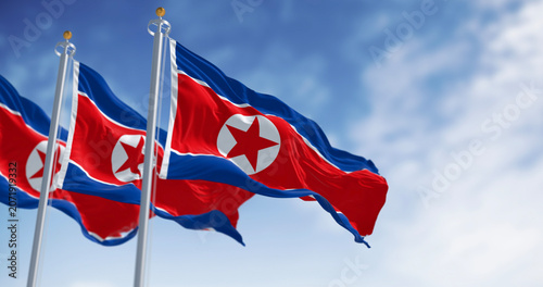 Close-up of North Korea national flags waving in the wind on a clear day
