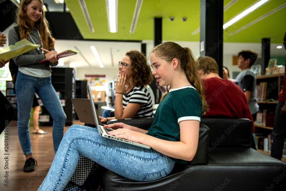 Fototapeta premium Students collaborating in modern library.