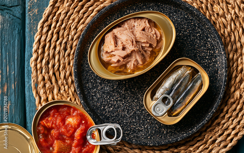 Open canned seafood featuring tuna, sardines, and mussels, showing preserved fish and shellfish as gourmet Spanish tapas