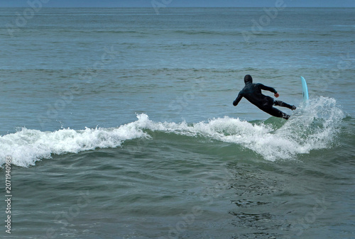 Surfing at the waves at the Westcoast of South Island New Zealand