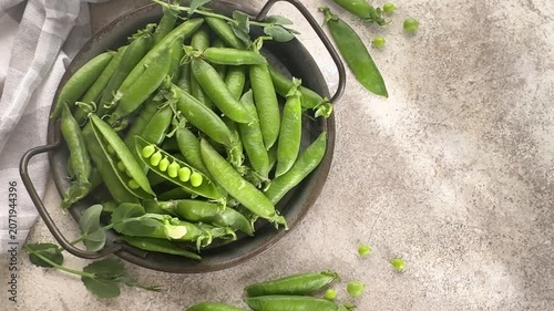 Fresh green peas in a rustic bowl