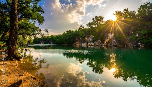 A serene lake surrounded by lush green trees and cliffs