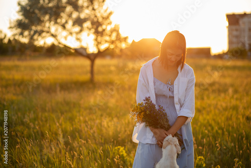 Tableau sur toile Affectionate moment between woman and her dog, outdoor lifestyle portrait