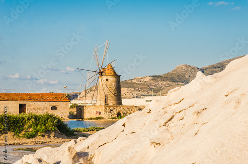 Trapani sea salt production view of old windmill at salt marches in Sicily, Italy	