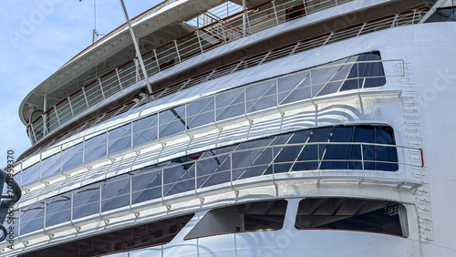 Obraz na plátně Cruise ship docked at harbor showing upper deck and windows
