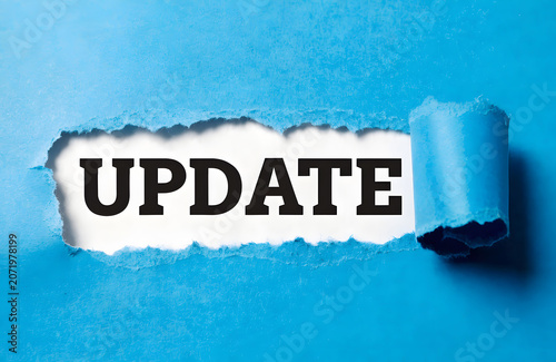 Paper Tear Reveal Showing Update Message On Blue Background For Business News Announcement And Information Concept