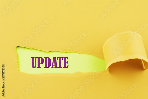 Paper Tear Reveal Showing Update Message On yellow Background For Business News Announcement And Information Concept