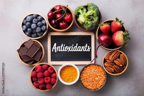 Assorted healthy antioxidant rich foods around a blackboard with antioxidants