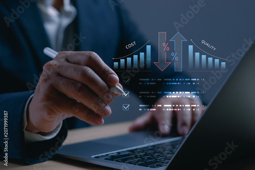 Obraz na plátně Businessman analyzing cost reduction and quality improvement strategy through digital performance metrics
