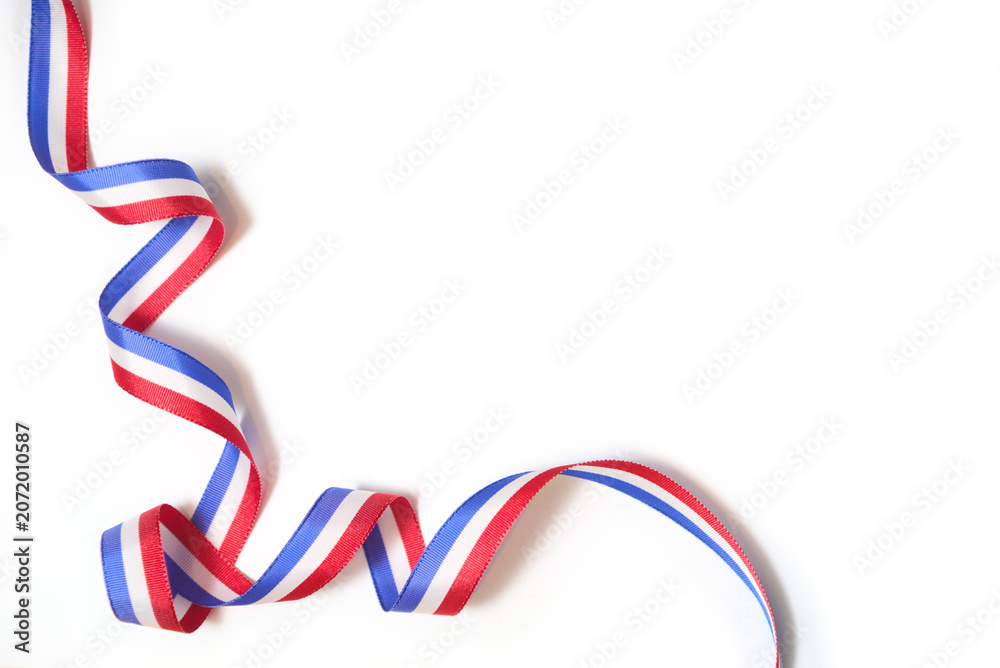 Fototapeta premium French flag colored ribbon twisted on white background in a design with copy space. Concept: celebration of national holidays or traditional festivals