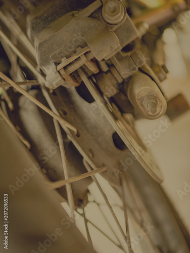 Close-Up Motorcycle Rear Wheel Spoke Disc Brake with Sepia Vintage Tone Style