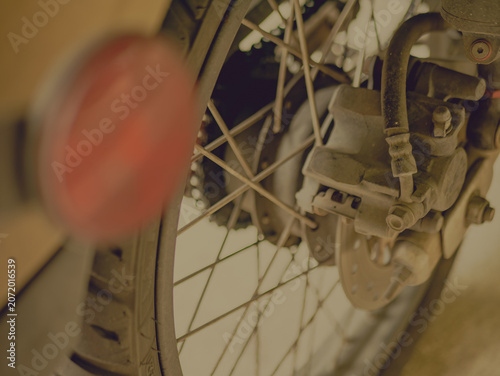 Close-Up Motorcycle Rear Wheel Spoke Disc Brake with Sepia Vintage Tone Style