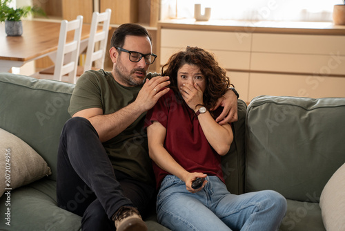 Fotografija Couple watching thrilling movie at home