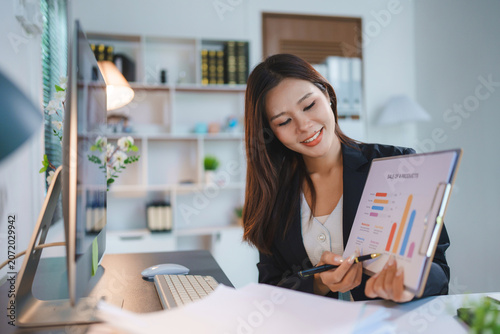 Businesswoman presenting financial analytics dashboard in modern office