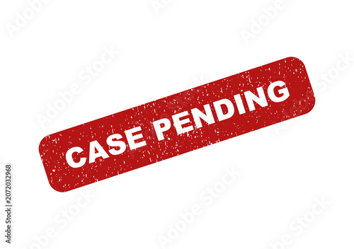 Red rubber stamp with the text case pending in a tilted position