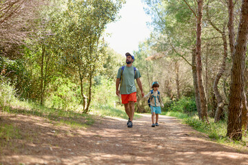 Father and son hiking in the forest
