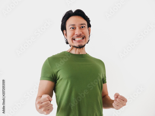 Excited energetic Asian man in green t-shirt with active pose isolated on white.