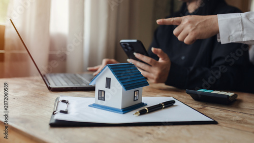 Businessman, house and condo sales representative Hand over the keys to the customer and sign the sales or rental contract according to mutual agreement in the office. Real estate business concept