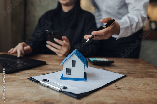 Businessman, house and condo sales representative Hand over the keys to the customer and sign the sales or rental contract according to mutual agreement in the office. Real estate business concept