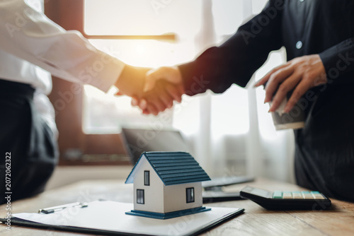 Businessman, house and condo sales representative Hand over the keys to the customer and sign the sales or rental contract according to mutual agreement in the office. Real estate business concept