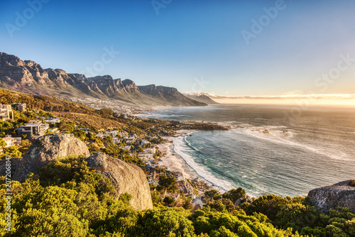 Cape Town Sunset over Camps Bay Beach with Table Mountain and Twelve Apostles in the Background