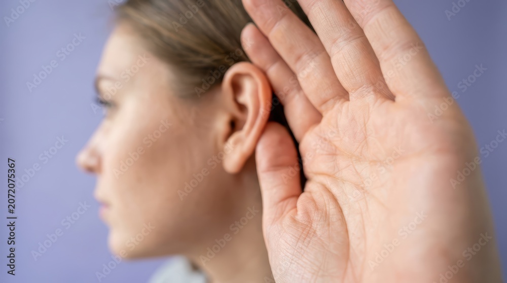 Fototapeta premium Hearing aid advertisement featuring a model demonstrating its use