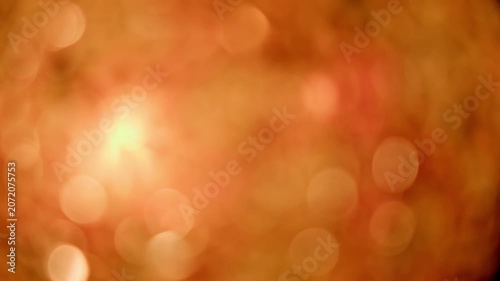 キャンドルの暖かな光が優しく揺らめく幻想的なオレンジ色の玉ボケのシームレスループ映像