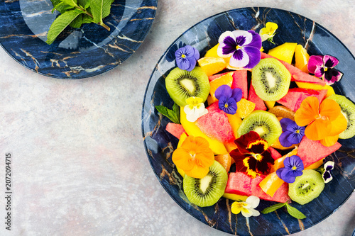 Vibrant Fruit Salad with Mango, Watermelon, Kiwi and Colorful Edible Flowers