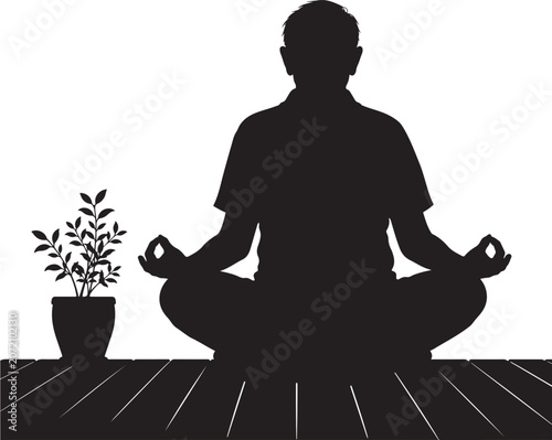 Man practicing yoga meditation sits in a peaceful pose next to a small potted houseplant indoors.
