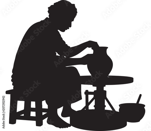Potter shapes a ceramic vessel on a spinning wheel in a traditional workshop setting.