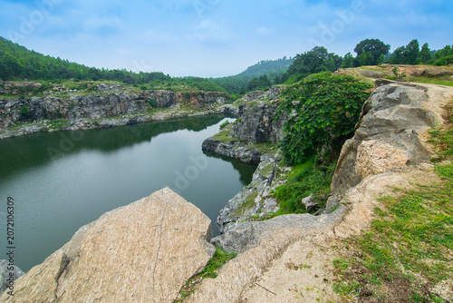 Top view of Tarpania Lake, Marble Lake, Blue Dam, Patal Dam or Durga Bera,a scenic lake in the Ajodhya Hills of Purulia, West Bengal, India. Water surrounded by sharp, white, marble-like rocky cliffs.