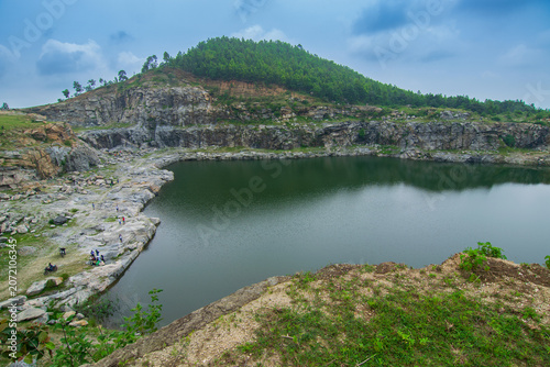 Top view of Tarpania Lake, Marble Lake, Blue Dam, Patal Dam or Durga Bera,a scenic lake in the Ajodhya Hills of Purulia, West Bengal, India. Water surrounded by sharp, white, marble-like rocky cliffs.