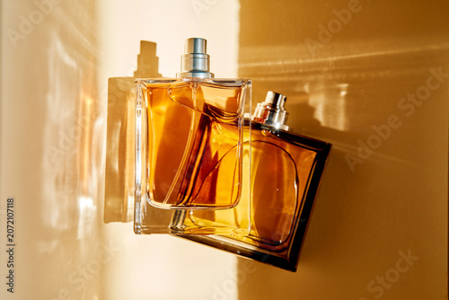 Perfume bottles reflecting sunlight, showcasing modern fragrance trends