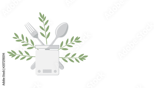 Valokuva Kitchen scale with a fork and spoon surrounded by green leaves on a white background