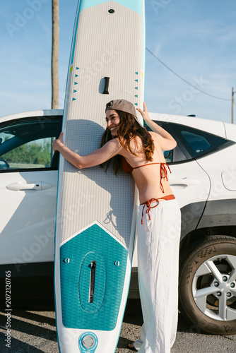 Woman preparing for summer paddleboard water sport adventure