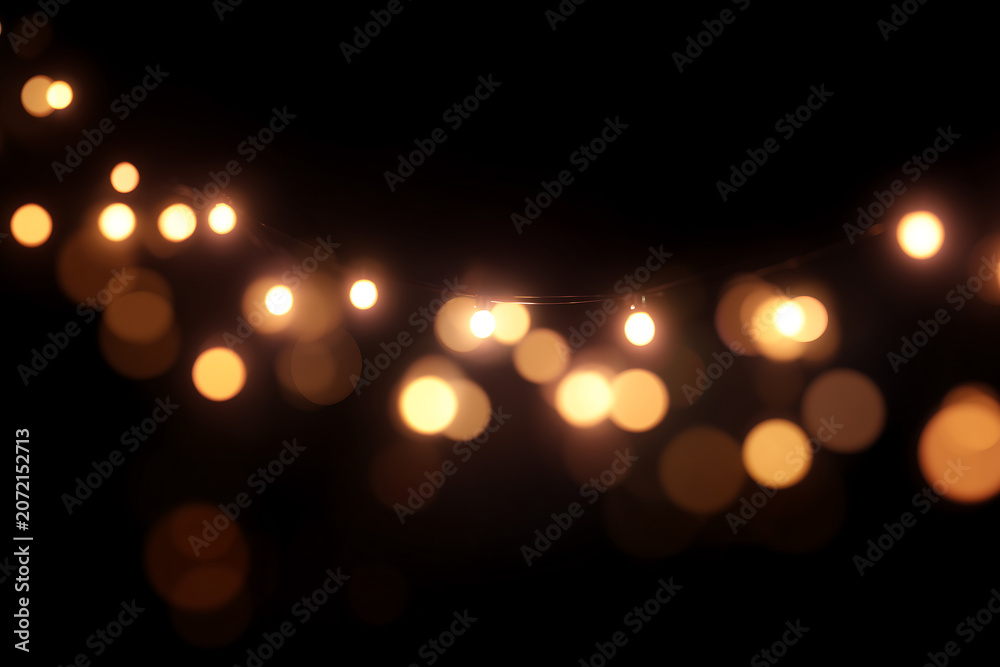 Fototapeta premium String Lights with Warm Glowing Bokeh, glow softly against