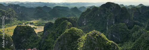 Billede på lærred Aerial view of towering limestone karst peaks covered with dense tropical forest