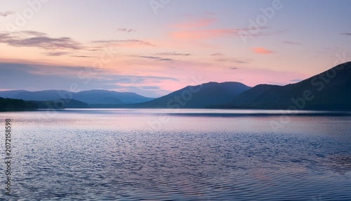 Calm Lake Horizon With Distant Mountains And Pastel Sky Serene Nature Landscape Background