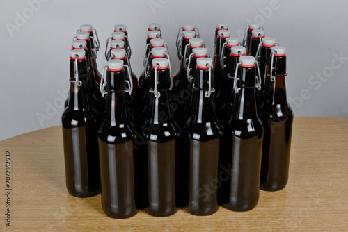 Grupo de botellas de cervezas artesanal con cierre hermético sobre mesa de madera