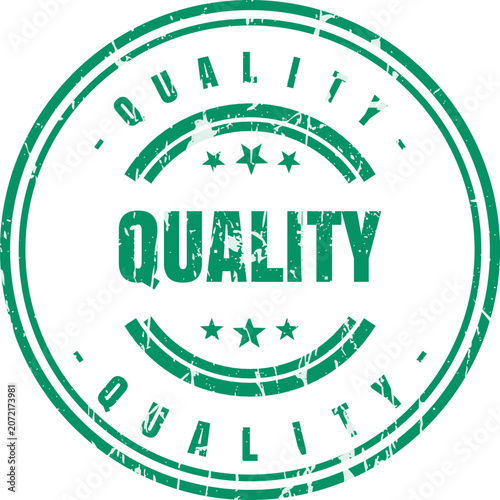 A circular green ink stamp with the word quality featuring a distressed and weathered texture