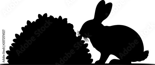 Black Silhouette of a Rabbit Eating Grass Isolated on a White Background for Nature Designs