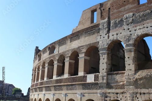 ROME, ITALY - JUNE 5, 2016: Upper arches and historic stone details of the Colosseum exterior
