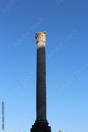 ROME, ITALY - JUNE 5, 2016: Roman column in the Roman Forum archaeological site under clear blue sky